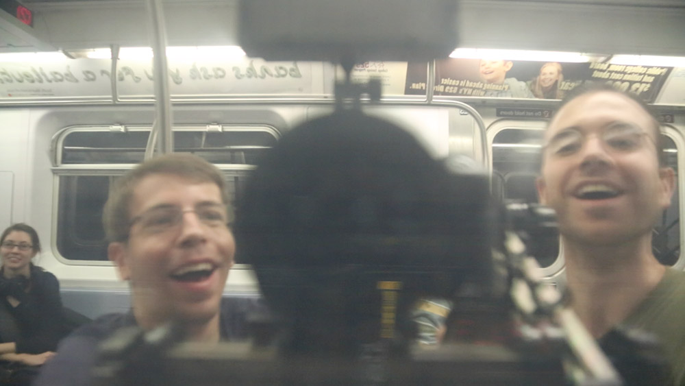 Adam, Andrew, and Paula riding the subway in New York