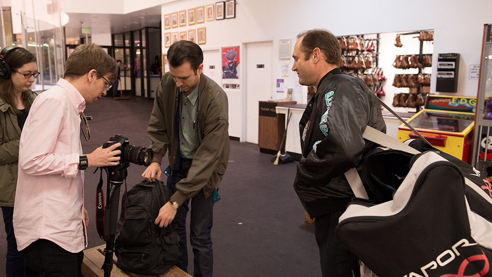 Adam, Andrew, and Paula filming at a convention